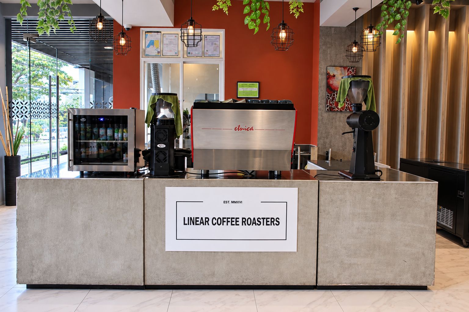 A coffee station with a sign reading 'LINEAR COFFEE ROASTERS' and a coffee machine.