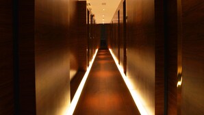 Ein Korridor mit Holzwänden und einer zentralen Lichtleiste.