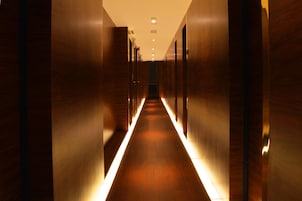 A corridor with wooden walls and a central light strip.
