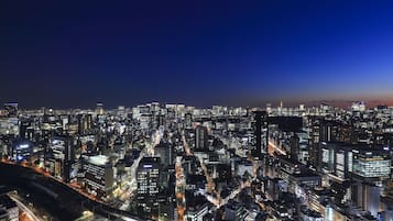 A nighttime cityscape with dense urban buildings and illuminated streets.
