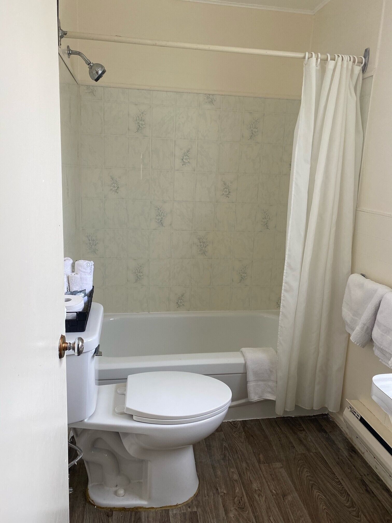 Ein Badezimmer mit Toilette, Badewanne und Duschvorhang.