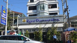 Exterior del Hotel Royal Diamond, con una señalización clara, una parada de taxis y un coche estacionado.