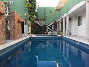 Outdoor pool, open 8:00 AM to 8:00 PM, pool loungers