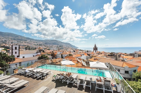 Indoor pool, outdoor pool, open 10:00 AM to 7:00 PM, pool umbrellas