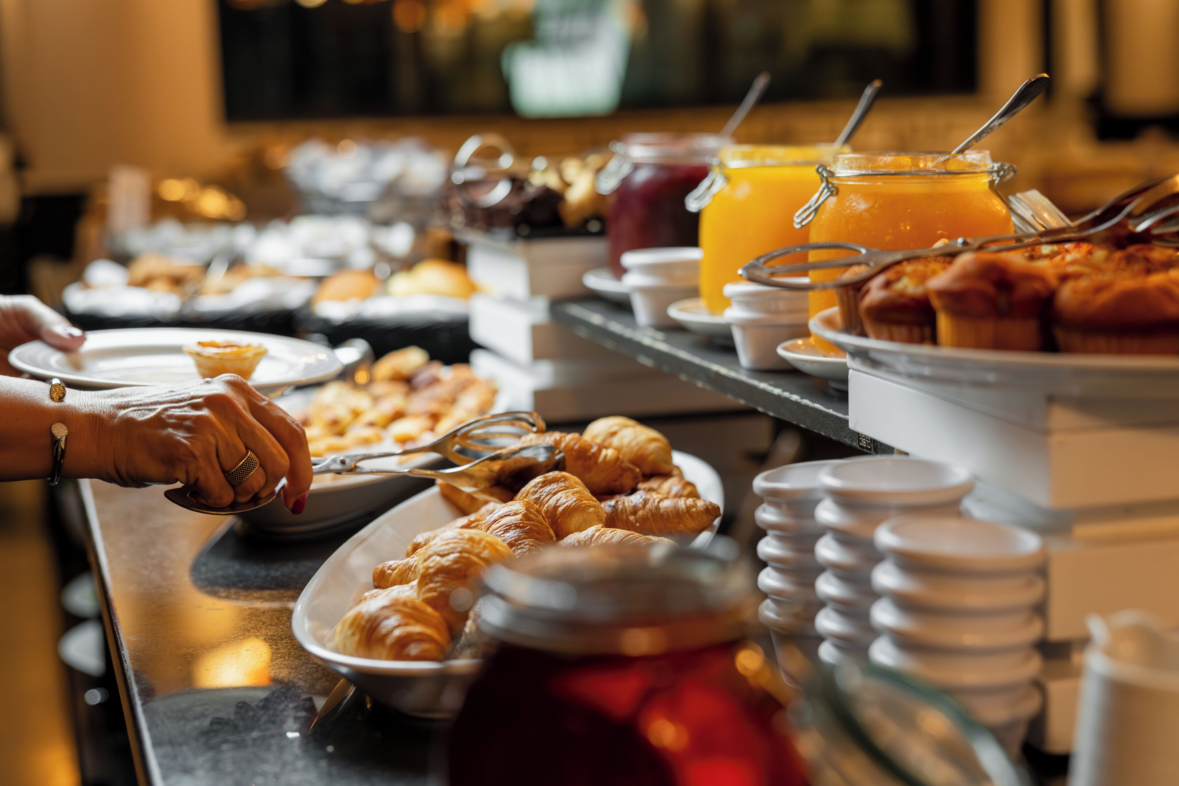 A buffet with various food items and beverages.