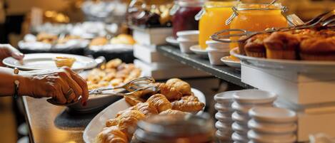 A buffet with various food items and beverages.