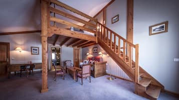 Family Suite | Living area | 26-inch flat-screen TV with cable channels, TV, heated floors