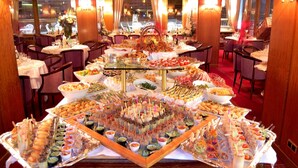 A buffet setup with various food items and a central decorative centerpiece.