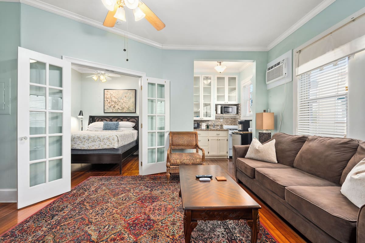A spacious living area with a sofa, a coffee table, and a patterned rug.