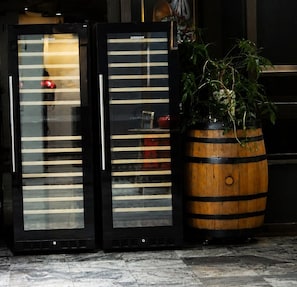 Two black refrigerators with the brand 'VENAX' and a wooden barrel with a plant. - PREMIUM FLATS BERRINI - BOUTIQUE HOTEL & SPA (São Paulo)