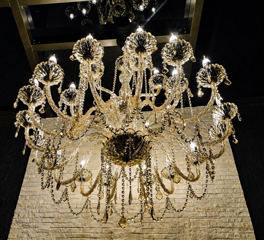A chandelier with multiple arms and hanging crystals.