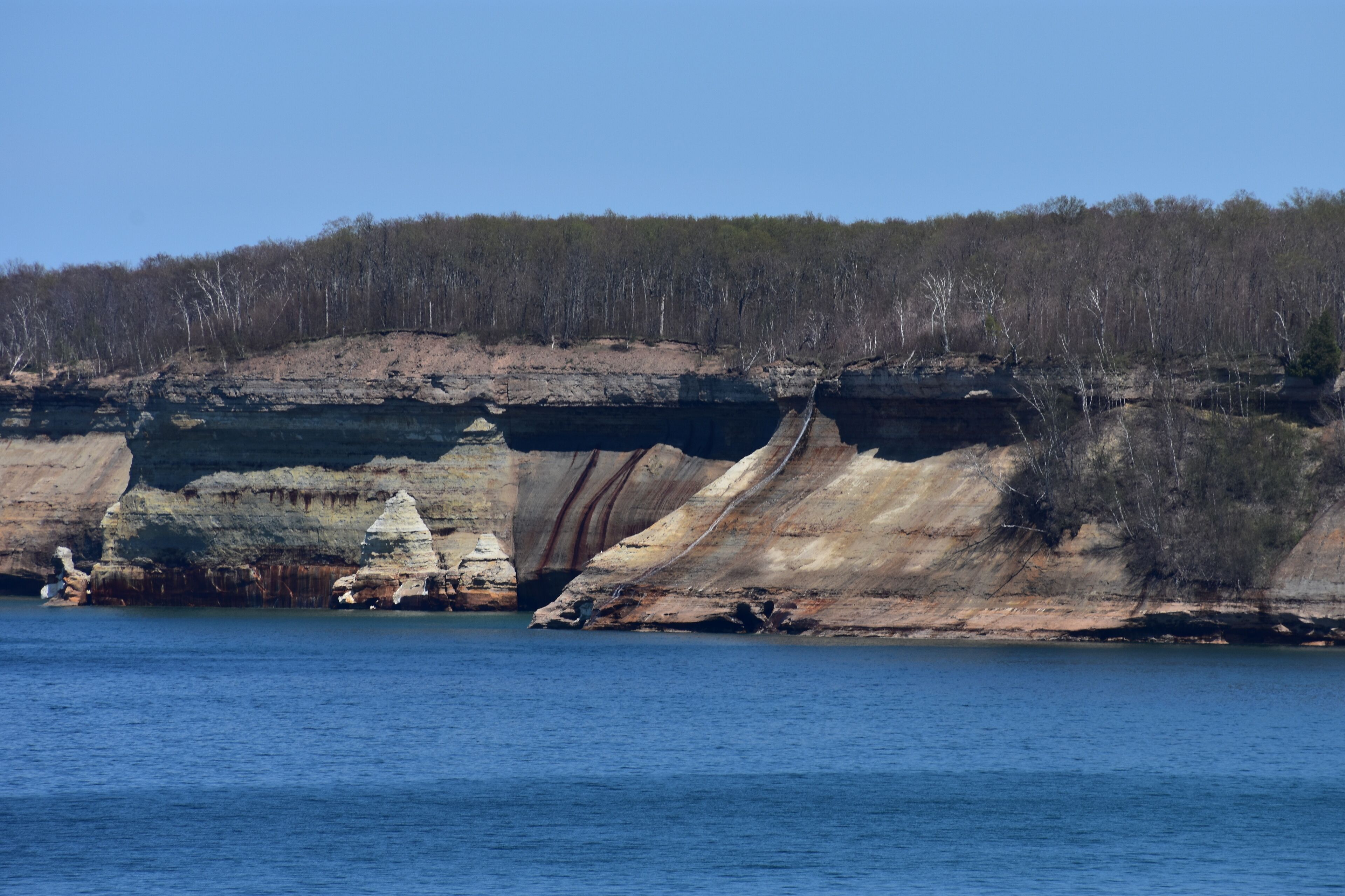 A coastal landscape with cliffs and a body of water.