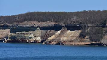 A coastal landscape with cliffs and a body of water.