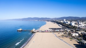 A coastal cityscape with a beach, pier, and urban buildings. - Ocean Lodge Santa Monica Beach Hotel (Santa Monica)