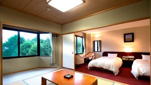 A hotel room with tatami mats, a wooden table, two beds, a chair, and a nightstand with a lamp. - Azumino Hotaka View Hotel (Azumino)