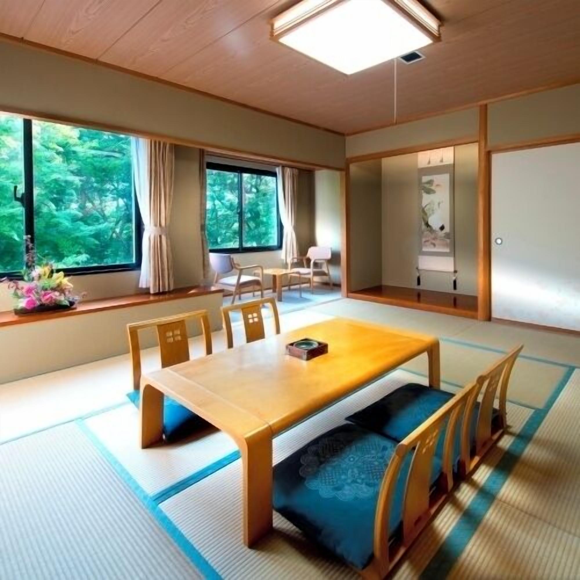 A traditional Japanese room with tatami flooring, a low table with cushions, and sliding doors.