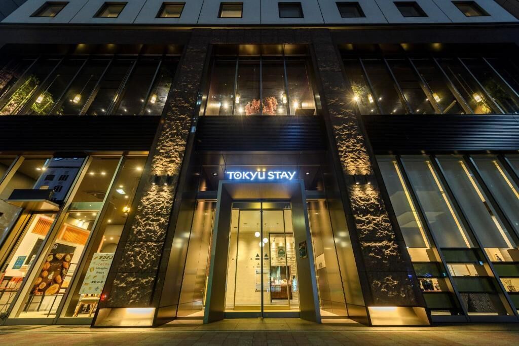 A modern building with a prominent entrance labeled 'TOKYU STAY'.