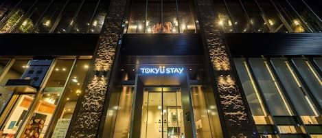A modern building with a prominent entrance labeled 'TOKYU STAY'.