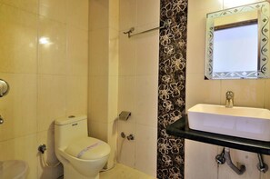 Bathroom features a toilet, sink, and mirror.