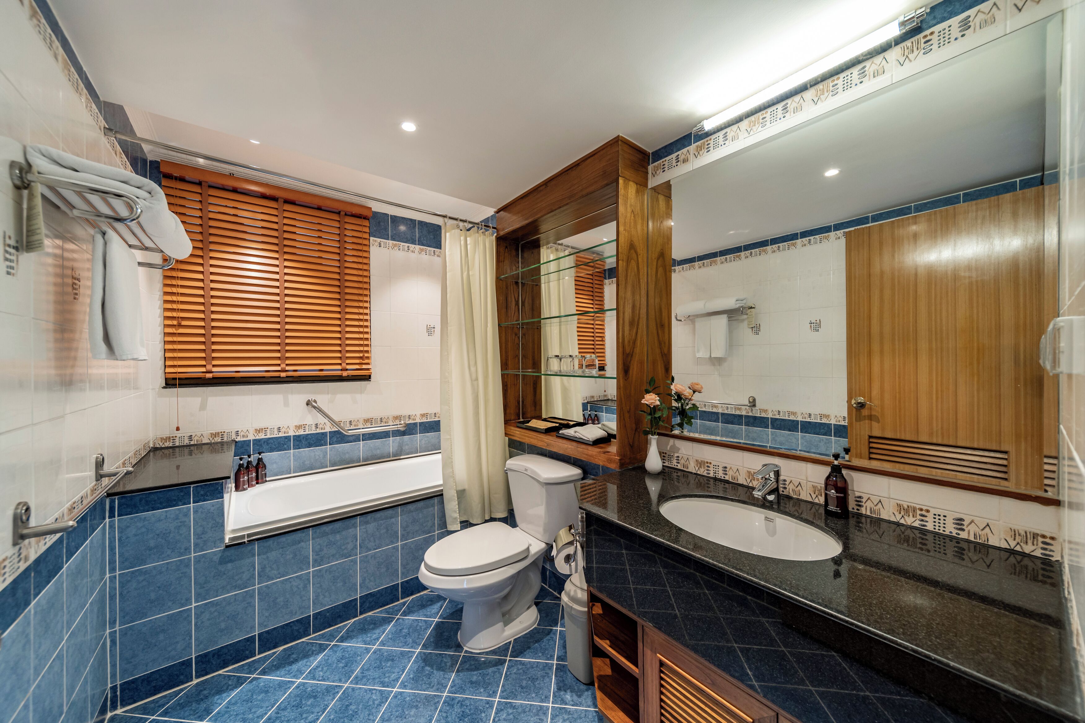 A modern bathroom with a bathtub, toilet, and sink.