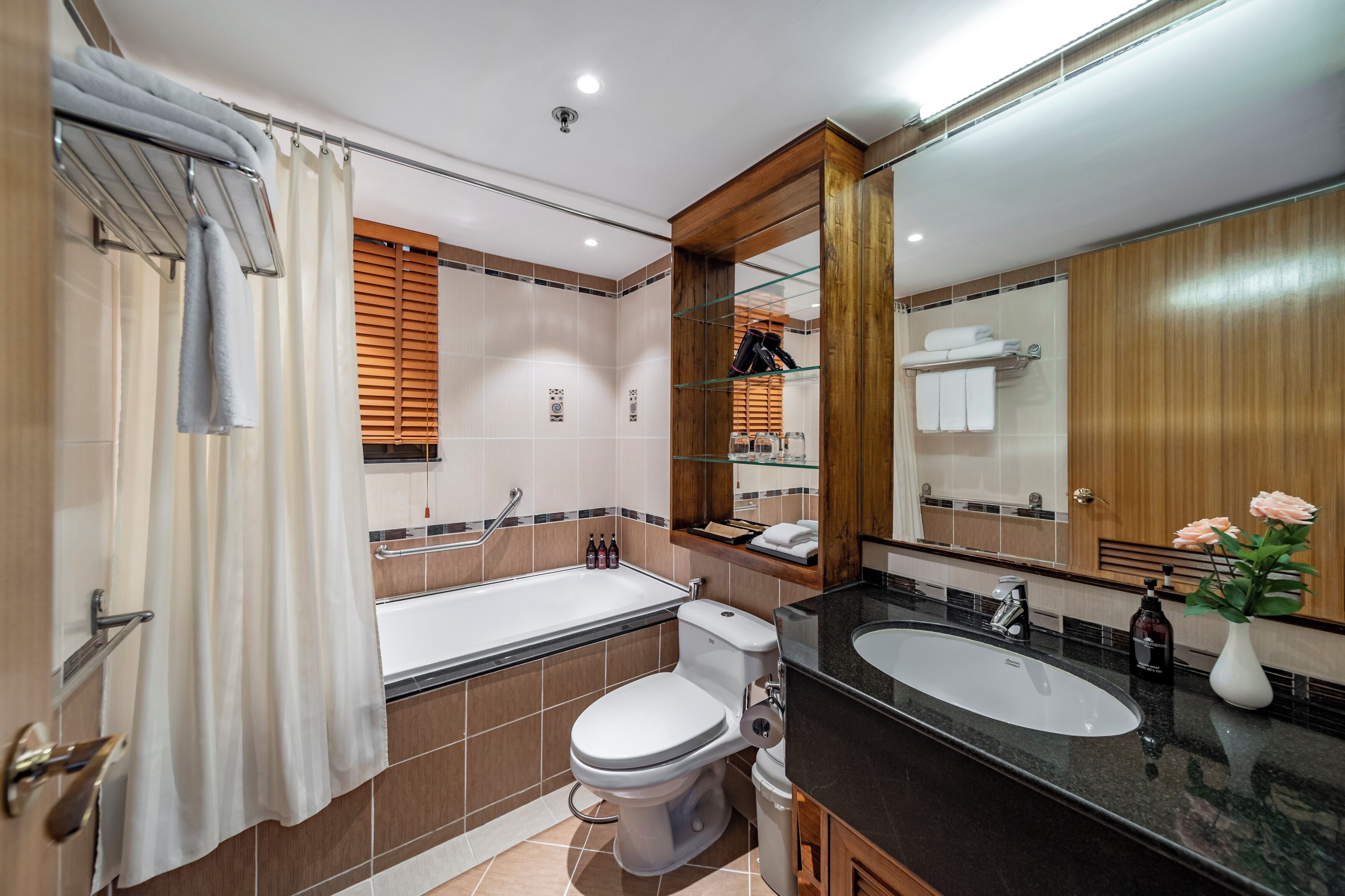 A modern bathroom with a bathtub, toilet, and sink.