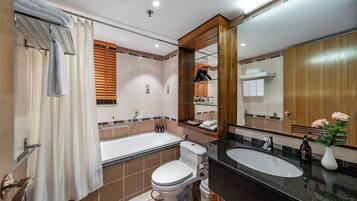 A modern bathroom with a bathtub, toilet, and sink.