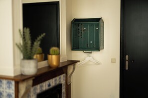A door with a simple handle, a small white hanger, and a green cabinet with a lock. - Boutique Hotel BE41 (Maastricht)
