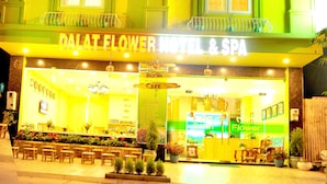A hotel with a sign reading "DALAT FLOWER HOTEL & SPA".