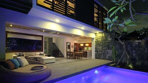 A modern house with a pool, outdoor seating, and a staircase leading to an upper level. - AbivillA Seminyak (Seminyak)