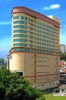 A multi-story hotel with a curved facade, numerous windows, and a flat roof.