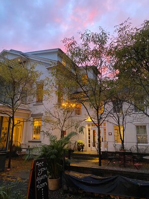 A building with a white facade, large windows, and a sign that reads "See you again soon." - Argos Inn (Ithaca)