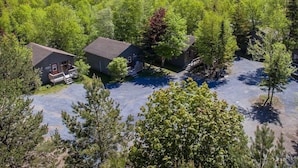 A residential area with two houses surrounded by dense forest. - Georges Mountain Village (Steady Brook)