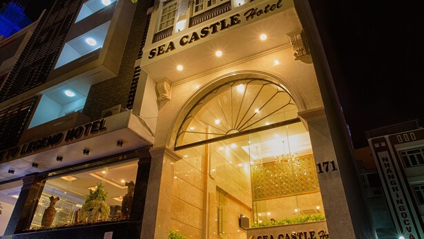 The Sea Castle Hotel with a prominent entrance, multiple floors, and a visible staircase leading to the entrance. - Sea Castle Hotel (Da Nang)