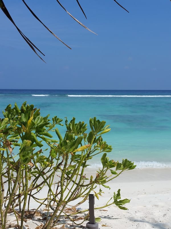 On the beach, white sand, beach towels, motor boating