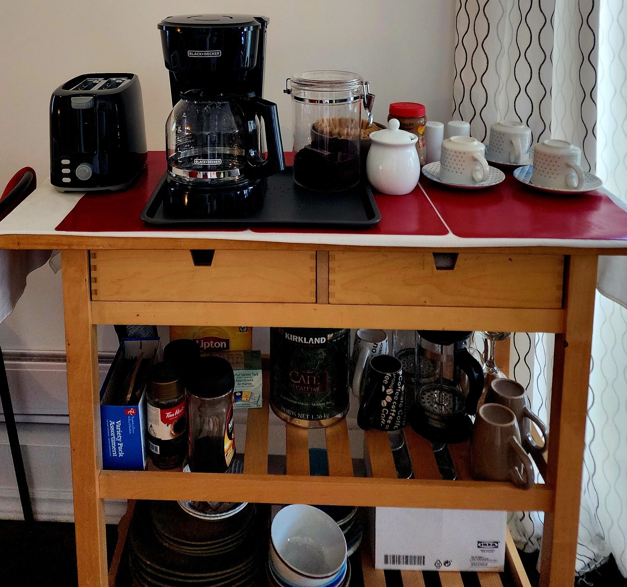 A kitchen counter with a coffee maker, a toaster, and various kitchen items.