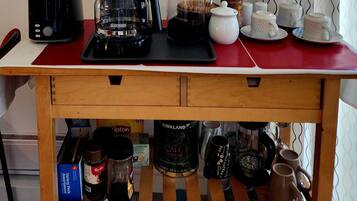 A kitchen counter with a coffee maker, a toaster, and various kitchen items.