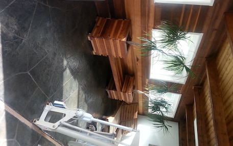 A high ceiling with wooden beams and a large window.