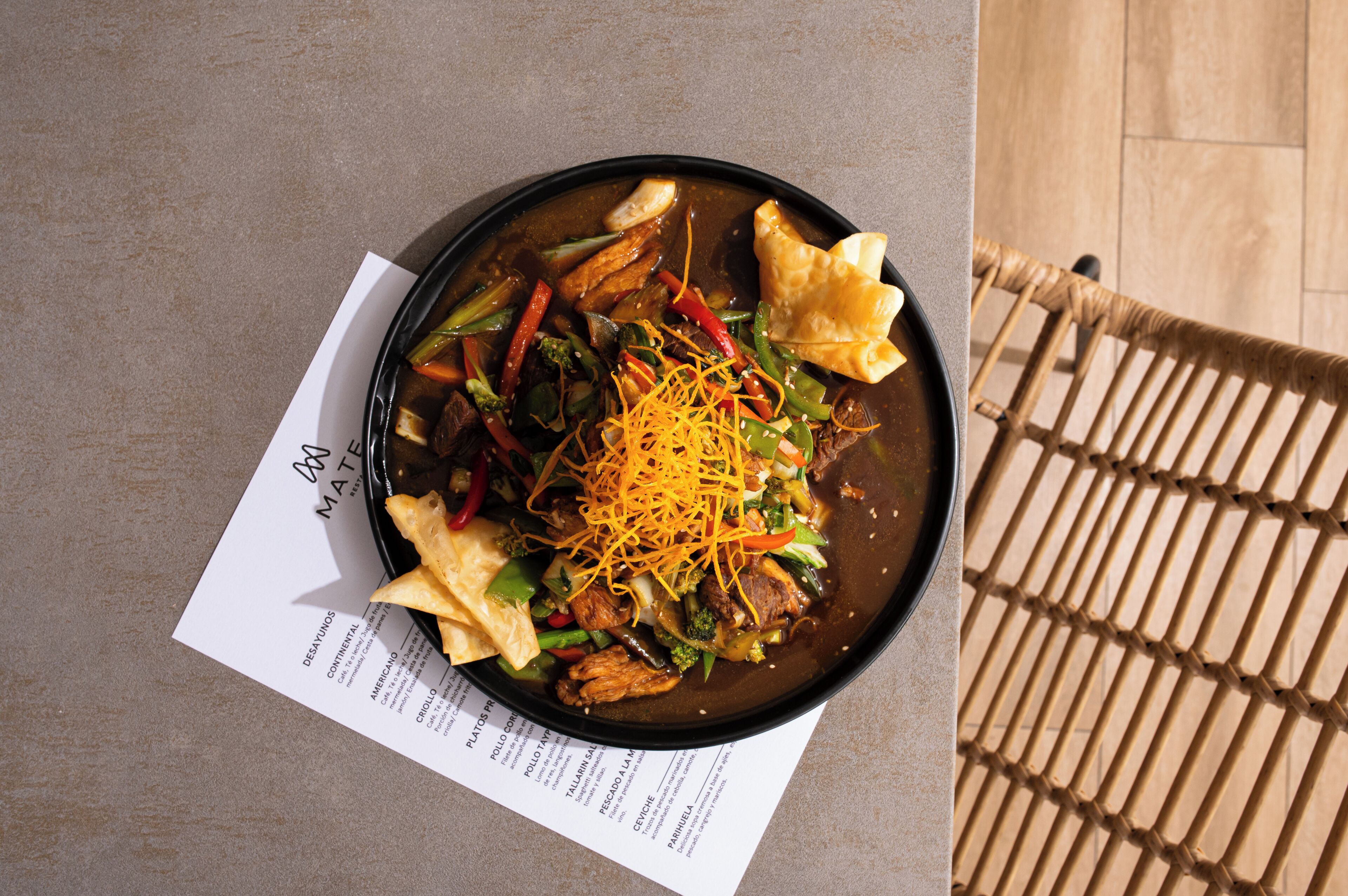 A bowl of food with a menu beside it.
