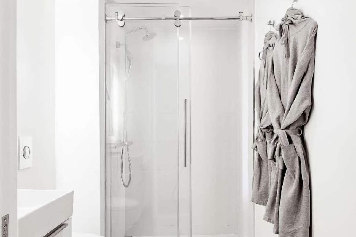 Bathroom | Designer toiletries, hair dryer, slippers, towels