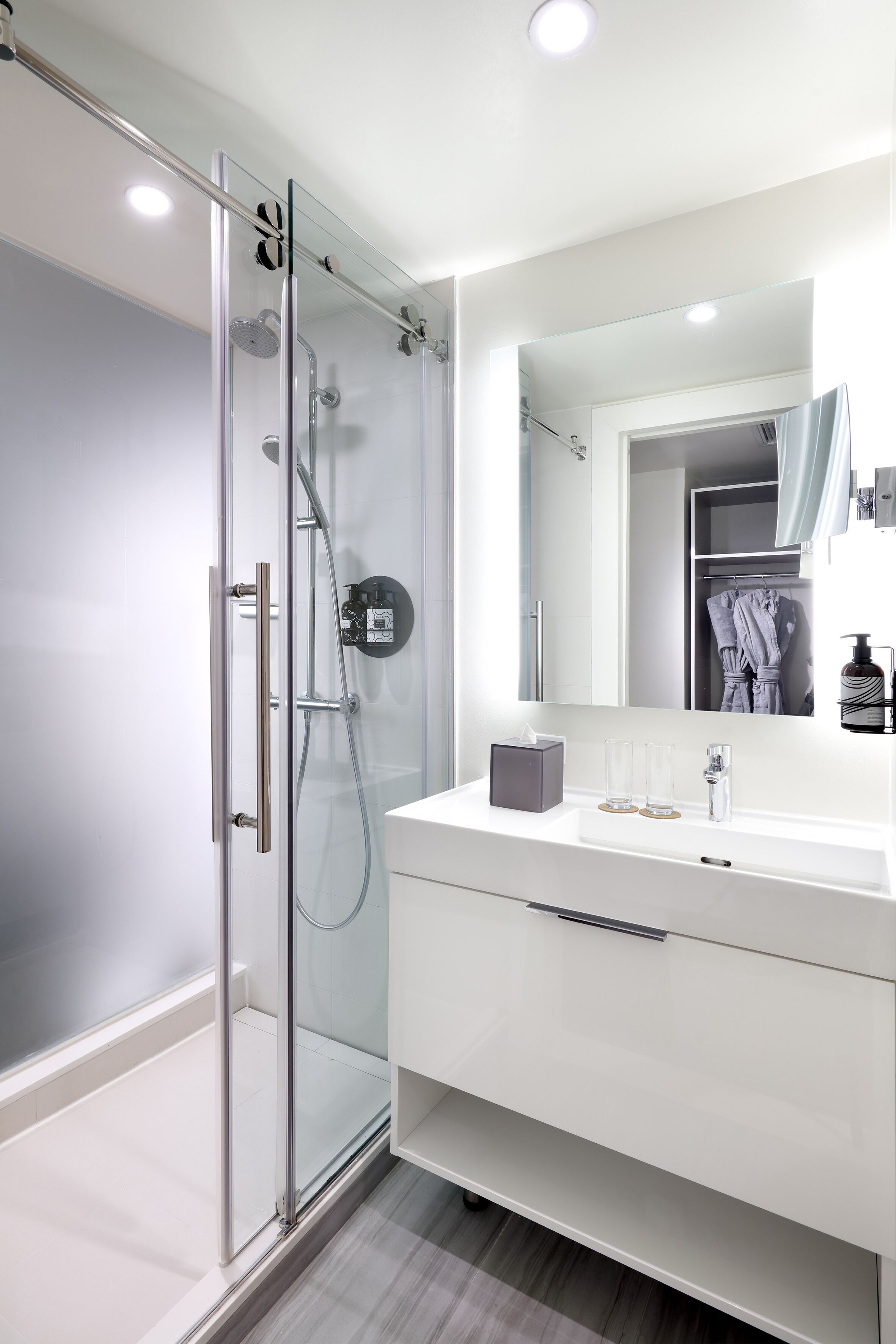 designer toiletries, hair dryer, slippers, towels