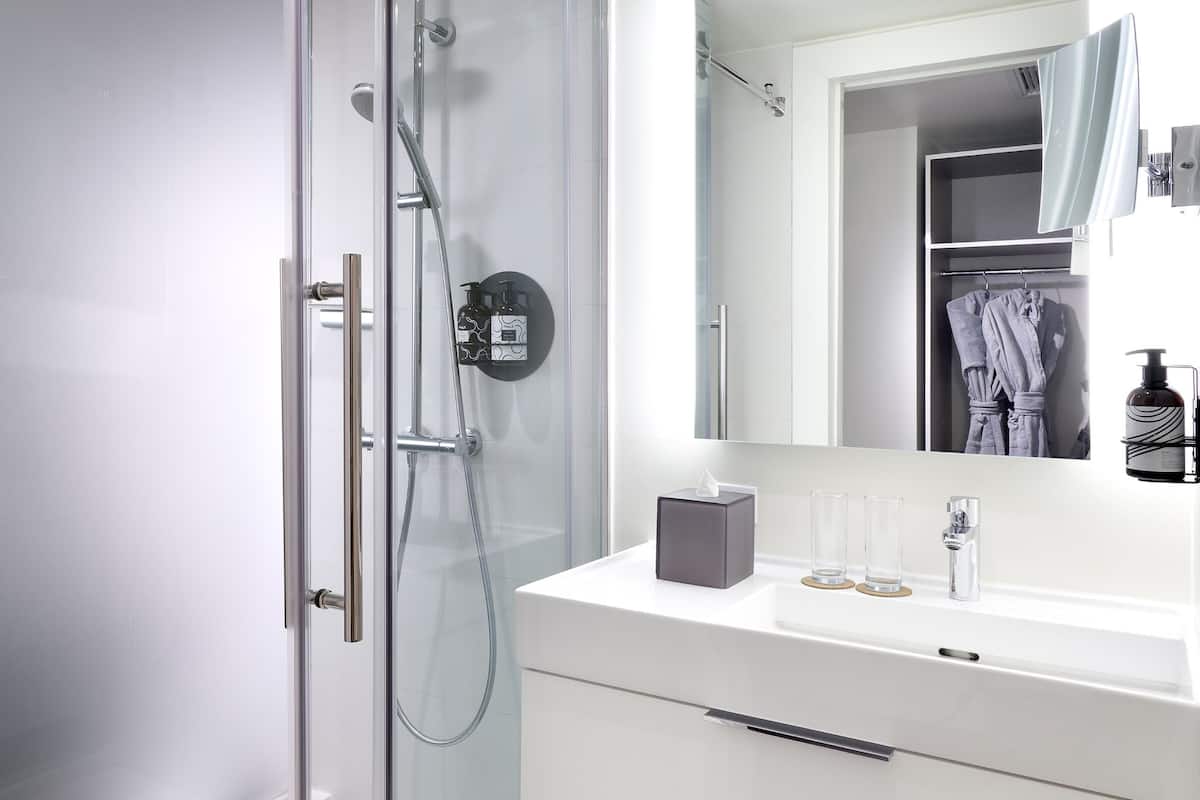 designer toiletries, hair dryer, slippers, towels