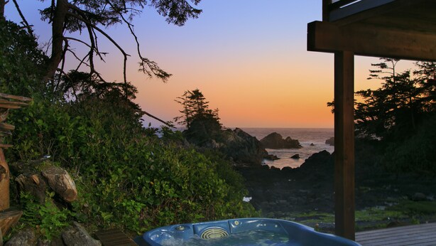 Ein Whirlpool mit Blick auf den Sonnenuntergang über dem Meer.