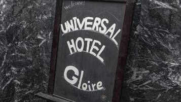 A signboard with "UNIVERSAL HOTEL" and "Gloire" written on it.
