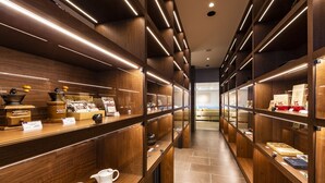 A modern interior with wooden shelving and a central counter displaying coffee equipment. - Bourou NOGUCHI Noboribetsu - Adult Only (Noboribetsu)