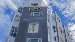A modern hotel building with a sign reading "Sailfish Hotel." - Sailing Hotel (Phu Quoc)