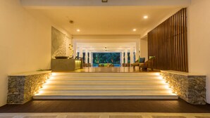 A grand staircase leading to a reception area with a stone wall on one side and a wooden panel on the other. - Palmstone Retreat - Kithulgala (Kithulgala)