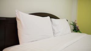 A neatly made bed with white linens and a dark headboard. - Su 22 (Bangkok)