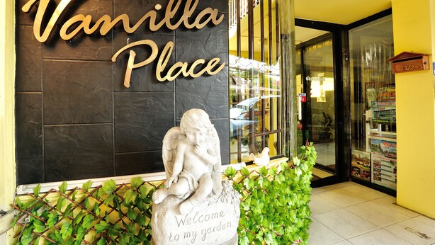 A storefront with a sign reading "Vanilla Place" and a welcoming garden statue. - Vanilla Place (Chiang Mai)