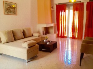 Family House, 2 Bedrooms, Bay View | Living area | 32-inch plasma TV with satellite channels, TV, fireplace - Nitelli's Houses (Lesvos)