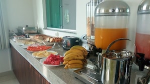 A buffet with various food items and a coffee station. - Front Hotel Expominas (Belo Horizonte)